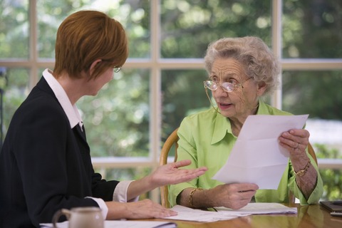 Advisor talking to elderly client